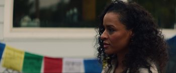 Movie still from “Summering” (2022), directed by James Ponsoldt – A person with curly black hair; Close Up shot, Over the shoulder angle