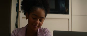 Movie still from “Summering” (2022), directed by James Ponsoldt – A young girl sitting in front of an open laptop computer; Close Up shot, Over the shoulder angle