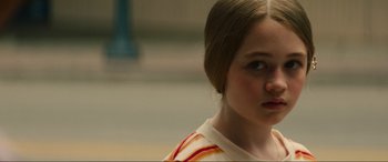 Movie still from “Summering” (2022), directed by James Ponsoldt – A young girl is looking into the distance; Close Up shot, Over the shoulder angle