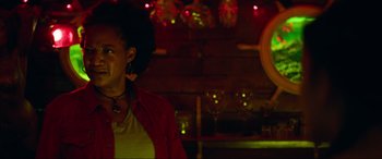 Movie still from “Summering” (2022), directed by James Ponsoldt – A woman in a red jacket standing next to a bar; Close Up shot, Low angle