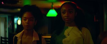 Movie still from “Summering” (2022), directed by James Ponsoldt – Two people standing in a room with a green light in the background; Close Up shot, Low angle