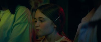 Movie still from “Summering” (2022), directed by James Ponsoldt – A young girl with a hairpin in her hair; Close Up shot, Over the shoulder angle