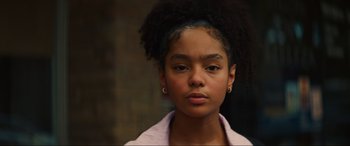 Movie still from “Summering” (2022), directed by James Ponsoldt – A young girl with an afro is posing for a picture; Close Up shot, Low angle