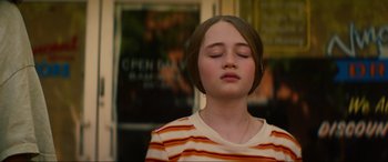 Movie still from “Summering” (2022), directed by James Ponsoldt – A young girl with her eyes closed with her eyes closed; Close Up shot, High angle