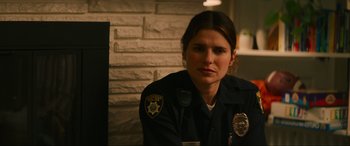 Movie still from “Summering” (2022), directed by James Ponsoldt – A police officer sitting in front of a brick wall; Close Up shot, Over the shoulder angle