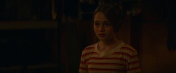 Movie still from “Summering” (2022), directed by James Ponsoldt – A girl in a striped shirt is looking at the camera; Close Up shot, Over the shoulder angle