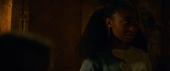 Movie still from “Summering” (2022), directed by James Ponsoldt – A person wearing a ear piece; Close Up shot, Over the shoulder angle