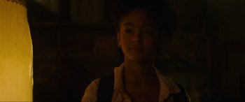 Movie still from “Summering” (2022), directed by James Ponsoldt – A young girl is standing in a dark room; Close Up shot, Over the shoulder angle