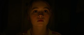 Movie still from “Summering” (2022), directed by James Ponsoldt – A young girl is looking up at the camera; Close Up shot, Low angle