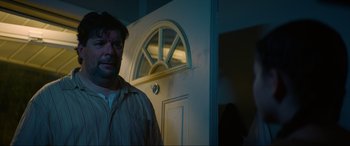 Movie still from “Summering” (2022), directed by James Ponsoldt – A man standing in front of a white door; Close Up shot, Low angle