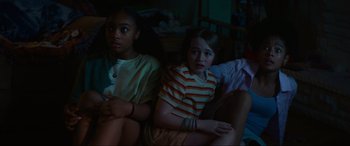 Movie still from “Summering” (2022), directed by James Ponsoldt – A group of young people sitting on a couch; Medium shot, High angle