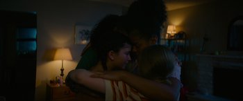 Movie still from “Summering” (2022), directed by James Ponsoldt – A group of people hugging each other in a dark room; Close Up shot, High angle