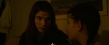 Movie still from “Summering” (2022), directed by James Ponsoldt – A woman looking at a girl in a dark room; Close Up shot, Over the shoulder angle