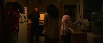 Movie still from “Summering” (2022), directed by James Ponsoldt – A group of people standing in a kitchen; Medium shot, Over the shoulder angle