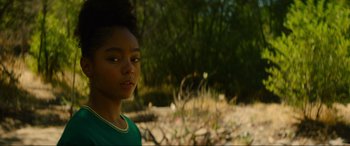 Movie still from “Summering” (2022), directed by James Ponsoldt – A young girl standing in the middle of a field; Close Up shot, Over the shoulder angle