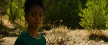 Movie still from “Summering” (2022), directed by James Ponsoldt – A young girl standing in the middle of a field; Close Up shot, Over the shoulder angle