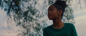 Movie still from “Summering” (2022), directed by James Ponsoldt – A young woman with her eyes closed in front of a tree; Close Up shot, Low angle