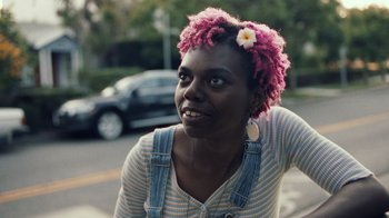 Movie still from “Summertime” (2020), directed by Carlos López Estrada – A woman with a flower in her pink hair; Close Up shot, Low angle