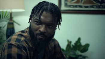Movie still from “Summertime” (2020), directed by Carlos López Estrada – A person with dreadlocks; Close Up shot, Over the shoulder angle