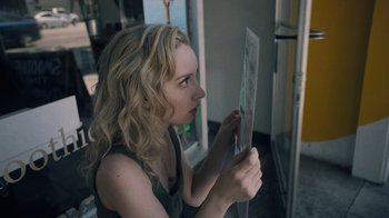 Movie still from “Summertime” (2020), directed by Carlos López Estrada – A woman holding a piece of paper in her hands; Close Up shot, Over the shoulder angle
