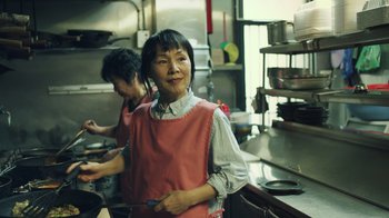 Movie still from “Summertime” (2020), directed by Carlos López Estrada – Two women in a kitchen preparing a meal together; Medium shot, Low angle