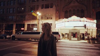 Movie still from “Summertime” (2020), directed by Carlos López Estrada – A woman walking down a street at night; Wide shot, Low angle