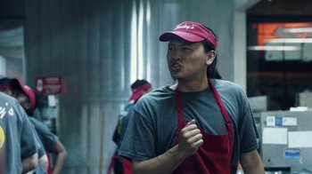 Movie still from “Summertime” (2020), directed by Carlos López Estrada – A man wearing a red hat and apron; Close Up shot, Low angle