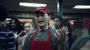 Movie still from “Summertime” (2020), directed by Carlos López Estrada – A group of people standing in a room; Close Up shot, High angle
