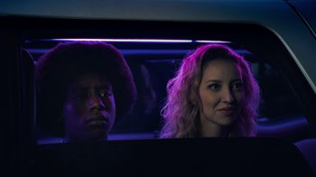 Movie still from “Summertime” (2020), directed by Carlos López Estrada – A man and a woman are looking at the camera in the dark; Close Up shot, Low angle