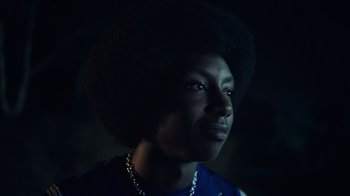 Movie still from “Summertime” (2020), directed by Carlos López Estrada – A man with a large afro is looking at the camera; Close Up shot, Low angle