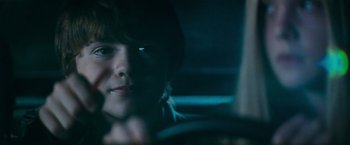 Movie still from “Super 8” (2011), directed by J.J. Abrams – A woman sitting in a car looking out the window at night; Close Up shot, Over the shoulder angle