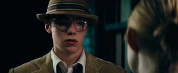 Movie still from “Super 8” (2011), directed by J.J. Abrams – A young man wearing a hat and glasses; Close Up shot, Low angle