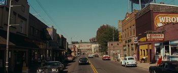 Movie still from “Super 8” (2011), directed by J.J. Abrams – Cars driving down a street in a small town; Extreme Wide shot, High angle