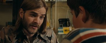 Movie still from “Super 8” (2011), directed by J.J. Abrams – A man with long hair talking to another man; Close Up shot, Over the shoulder angle