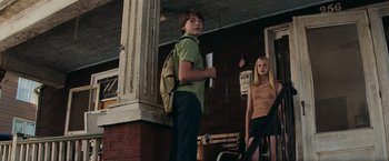 Movie still from “Super 8” (2011), directed by J.J. Abrams – A boy and a girl standing next to each other; Medium shot, Low angle