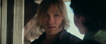 Movie still from “Super 8” (2011), directed by J.J. Abrams – A person with long blonde hair; Close Up shot, Over the shoulder angle