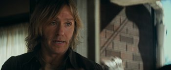 Movie still from “Super 8” (2011), directed by J.J. Abrams – A person with long blonde hair; Close Up shot, Over the shoulder angle