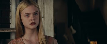 Movie still from “Super 8” (2011), directed by J.J. Abrams – A woman with long blonde hair is looking at the camera; Close Up shot, Over the shoulder angle