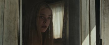 Movie still from “Super 8” (2011), directed by J.J. Abrams – A young girl with long blonde hair looking into a mirror; Close Up shot, Low angle