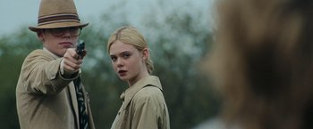 Movie still from “Super 8” (2011), directed by J.J. Abrams – A woman with blonde hair and a brown jacket; Close Up shot, Over the shoulder angle