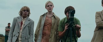 Movie still from “Super 8” (2011), directed by J.J. Abrams – A group of people standing next to each other; Medium shot, Low angle