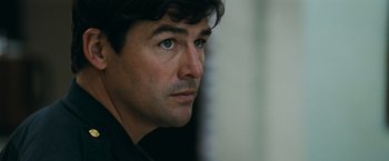 Movie still from “Super 8” (2011), directed by J.J. Abrams – A man's face looking into the distance; Close Up shot, Over the shoulder angle