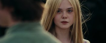 Movie still from “Super 8” (2011), directed by J.J. Abrams – A person with blonde hair; Close Up shot, Over the shoulder angle