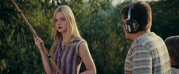 Movie still from “Super 8” (2011), directed by J.J. Abrams – A woman standing next to a man in a field; Medium shot, Over the shoulder angle