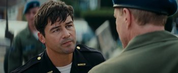 Movie still from “Super 8” (2011), directed by J.J. Abrams – A man wearing a uniform talking to another man; Close Up shot, Over the shoulder angle