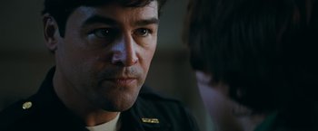 Movie still from “Super 8” (2011), directed by J.J. Abrams – A person wearing a black jacket; Close Up shot, Over the shoulder angle