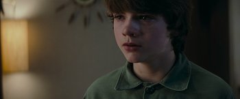 Movie still from “Super 8” (2011), directed by J.J. Abrams – A young boy is looking into the distance; Close Up shot, Over the shoulder angle