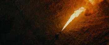 Movie still from “Super 8” (2011), directed by J.J. Abrams – Two people are standing in the middle of a cave; Extreme Wide shot, Overhead angle