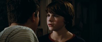 Movie still from “Super 8” (2011), directed by J.J. Abrams – A young boy is looking at a younger boy; Close Up shot, Over the shoulder angle
