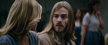 Movie still from “Super 8” (2011), directed by J.J. Abrams – A person with long blonde hair; Close Up shot, Over the shoulder angle
